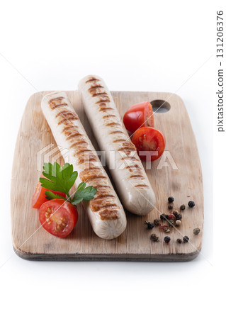Grilled white sausages with cherry tomatoes and parsley Grilled white sausages with cherry tomatoes and parsley 131206376