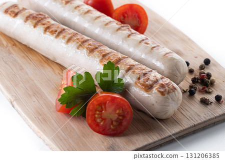 Grilled white sausages with cherry tomatoes and parsley Grilled white sausages with cherry tomatoes and parsley 131206385