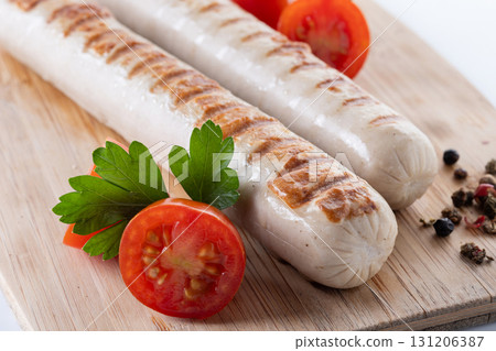 Grilled white sausages with cherry tomatoes and parsley Grilled white sausages with cherry tomatoes and parsley 131206387