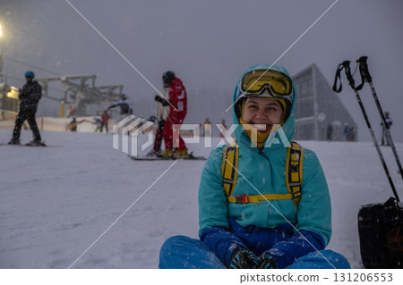 Skier Resting on Snowy Slope at Ski Resort Skier Resting on Snowy Slope at Ski Resort 131206553