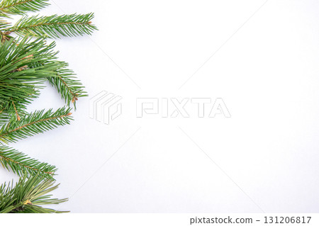 Fresh pine branches arranged on a clean white background for holiday decoration or crafting purposes during winter festivities 131206817