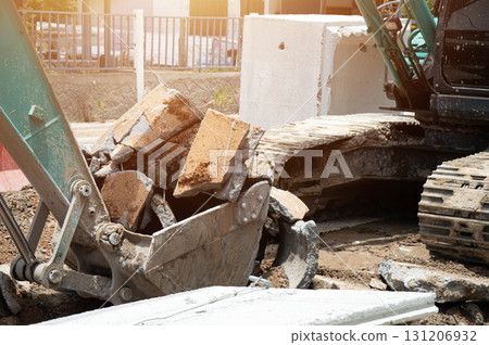 A large excavator is working on a construction site. 131206932