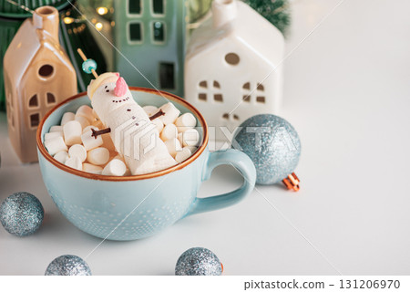 Marshmallow Snowman in Mug with Christmas Ornaments and Lights Marshmallow Snowman in Mug with Christmas Ornaments and Lights 131206970