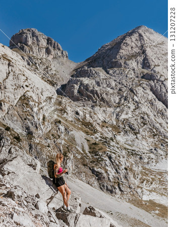 Woman Hiker Taking Break during Mountain Ascent 131207228