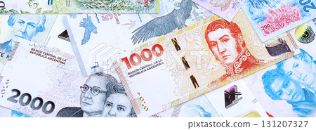 Argentine pesos money bills in big amount lies on white table close up. Finance and banking concept Argentine pesos money bills in big amount lies on white table close up. Finance and banking concept 131207327