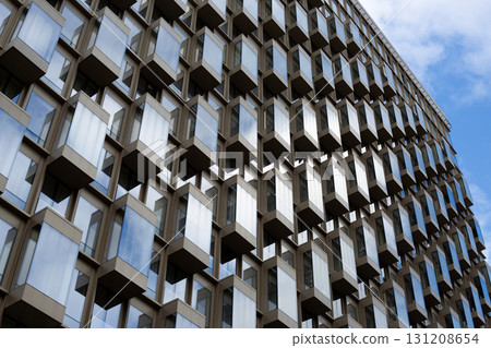 Photo of modern building with intricate geometric design. This image is ideal for topics related to urban architecture, innovative construction techniques and contemporary design aesthetics Photo of modern building with intricate geometric design. This image is ideal for topics related to urban architecture, innovative construction techniques and contemporary design aesthetics 131208654