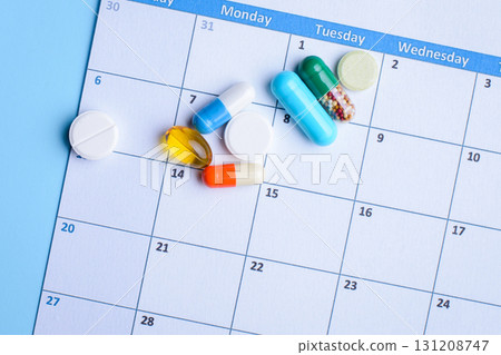 Pills on a calendar daily and weekly schedule 131208747