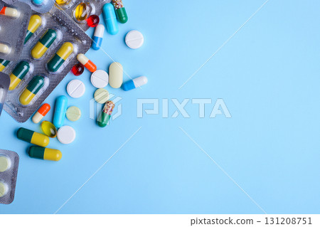 Background of pills, capsules, drugs on light blue background 131208751