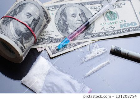 Drug Abuse. Drugs in plastic zip packaging, syringe with some liquid and dollar bills on black glass table 131208754