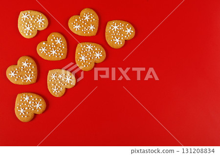 beautiful hand-baked cookies in the shape of a heart on a red background 131208834