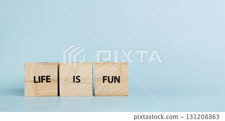 Wooden cubes with inscriptions Let Is Fun on a blue background Wooden cubes with inscriptions Let Is Fun on a blue background 131208863