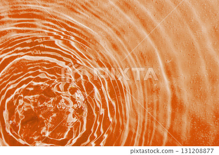 drops on water with circles on a orange background drops on water with circles on a orange background 131208877