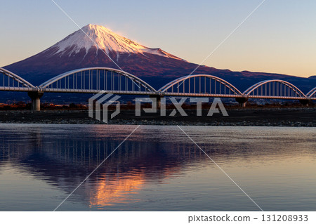 Inverted red Fuji and railway bridge reflected in the Fuji River _ Morning glow 131208933