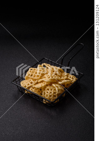 Lattice or wafer potato chips, crispy yellow snacks, takeaway food Lattice or wafer potato chips, crispy yellow snacks, takeaway food 131209124