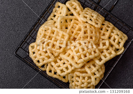 Lattice or wafer potato chips, crispy yellow snacks, takeaway food Lattice or wafer potato chips, crispy yellow snacks, takeaway food 131209168