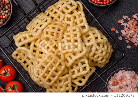 Lattice or wafer potato chips, crispy yellow snacks, takeaway food Lattice or wafer potato chips, crispy yellow snacks, takeaway food 131209172