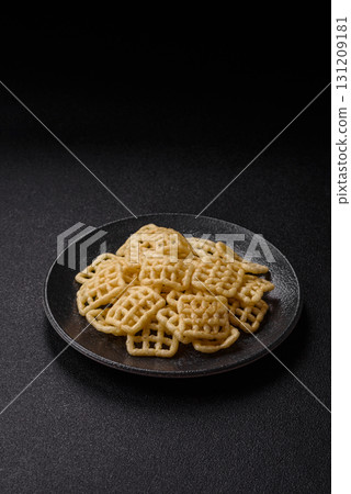Lattice or wafer potato chips, crispy yellow snacks, takeaway food Lattice or wafer potato chips, crispy yellow snacks, takeaway food 131209181