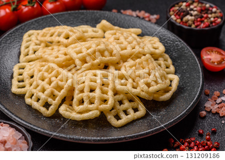 Lattice or wafer potato chips, crispy yellow snacks, takeaway food Lattice or wafer potato chips, crispy yellow snacks, takeaway food 131209186