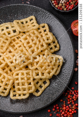 Lattice or wafer potato chips, crispy yellow snacks, takeaway food Lattice or wafer potato chips, crispy yellow snacks, takeaway food 131209188