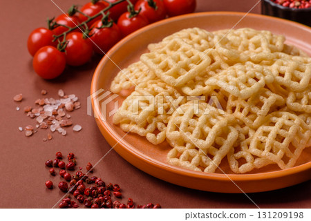 Lattice or wafer potato chips, crispy yellow snacks, takeaway food Lattice or wafer potato chips, crispy yellow snacks, takeaway food 131209198