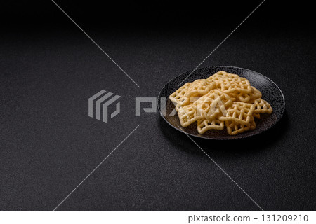 Lattice or wafer potato chips, crispy yellow snacks, takeaway food Lattice or wafer potato chips, crispy yellow snacks, takeaway food 131209210