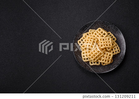Lattice or wafer potato chips, crispy yellow snacks, takeaway food 131209211