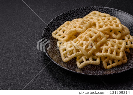 Lattice or wafer potato chips, crispy yellow snacks, takeaway food Lattice or wafer potato chips, crispy yellow snacks, takeaway food 131209214
