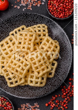 Lattice or wafer potato chips, crispy yellow snacks, takeaway food Lattice or wafer potato chips, crispy yellow snacks, takeaway food 131209220
