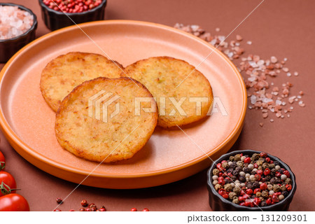 Hash browns, a breakfast food made of potatoes, onions and vegetables. Hash browns with potatoes 131209301