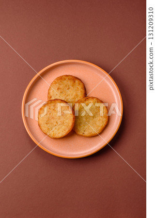 Hash browns, a breakfast food made of potatoes, onions and vegetables. Hash browns with potatoes 131209310