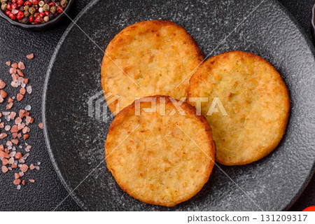Hash browns, a breakfast food made of potatoes, onions and vegetables. Hash browns with potatoes 131209317