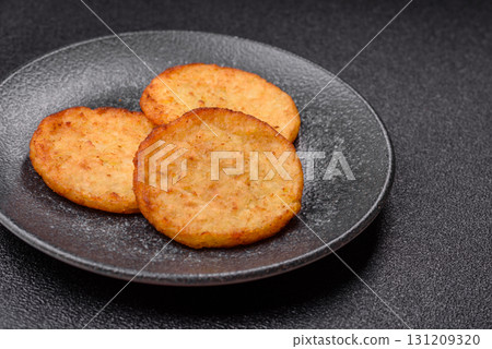 Hash browns, a breakfast food made of potatoes, onions and vegetables. Hash browns with potatoes 131209320