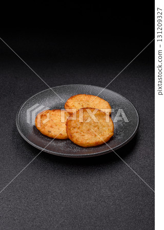 Hash browns, a breakfast food made of potatoes, onions and vegetables. Hash browns with potatoes 131209327