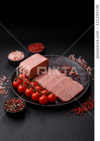 Food, meat, ham sliced in slices for the festive table. Spiced ham 131209336