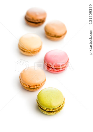 Different flavors of macarons. Colourful macaroons isolated on white background. Different flavors of macarons. Colourful macaroons isolated on white background. 131209359