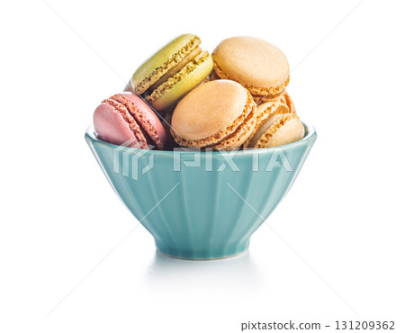 Different flavors of macarons. Colourful macaroons in bowl isolated on white background. 131209362