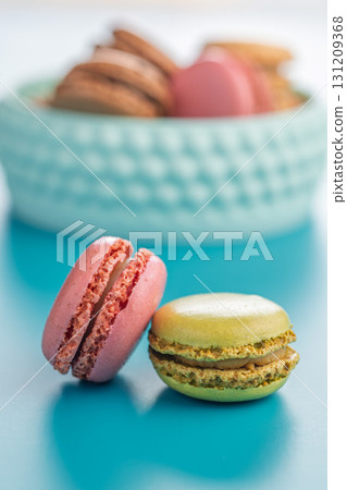 Different flavors of macarons. Colourful macaroons on blue background. 131209368