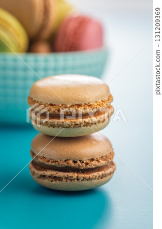 Different flavors of macarons. Colourful macaroons on blue background. 131209369
