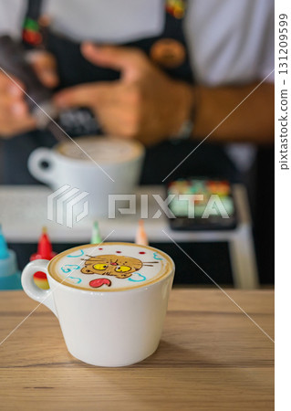 Cute latte art in form of cartoon cat with colorful elements served in white cup on wooden table. Concept of latte art, coffee creativity and fun cafe experience Cute latte art in form of cartoon cat with colorful elements served in white cup on wooden table. Concept of latte art, coffee creativity and fun cafe experience 131209599