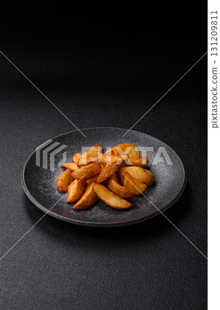 Grilled potato wedges with rosemary, cheese, salt and spices. Baked potato slices Grilled potato wedges with rosemary, cheese, salt and spices. Baked potato slices 131209811