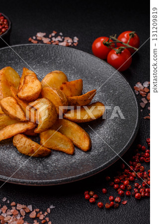 Grilled potato wedges with rosemary, cheese, salt and spices. Baked potato slices Grilled potato wedges with rosemary, cheese, salt and spices. Baked potato slices 131209819