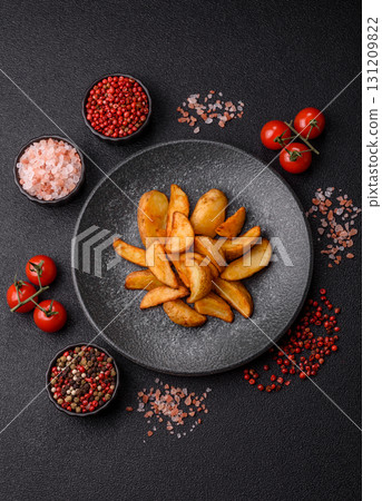 Grilled potato wedges with rosemary, cheese, salt and spices. Baked potato slices 131209822
