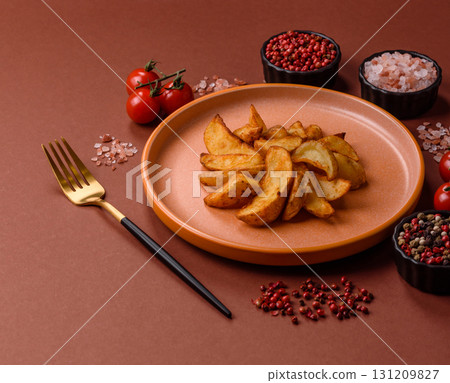 Grilled potato wedges with rosemary, cheese, salt and spices. Baked potato slices Grilled potato wedges with rosemary, cheese, salt and spices. Baked potato slices 131209827