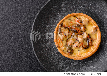 Pie or quiche, a sour tart with chicken and mushrooms, spices and herbs. Round quiche with chicken 131209919