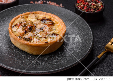 Pie or quiche, a sour tart with chicken and mushrooms, spices and herbs. Round quiche with chicken Pie or quiche, a sour tart with chicken and mushrooms, spices and herbs. Round quiche with chicken 131209922