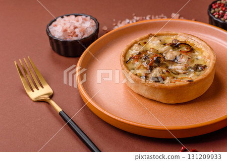 Pie or quiche, a sour tart with chicken and mushrooms, spices and herbs. Round quiche with chicken Pie or quiche, a sour tart with chicken and mushrooms, spices and herbs. Round quiche with chicken 131209933