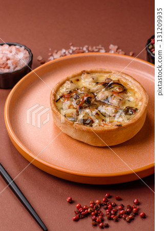 Pie or quiche, a sour tart with chicken and mushrooms, spices and herbs. Round quiche with chicken Pie or quiche, a sour tart with chicken and mushrooms, spices and herbs. Round quiche with chicken 131209935