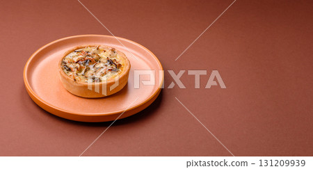 Pie or quiche, a sour tart with chicken and mushrooms, spices and herbs. Round quiche with chicken 131209939
