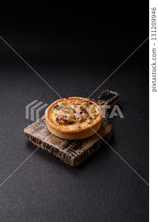 Pie or quiche, a sour tart with chicken and mushrooms, spices and herbs. Round quiche with chicken 131209946