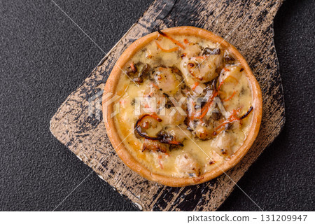 Pie or quiche, a sour tart with chicken and mushrooms, spices and herbs. Round quiche with chicken 131209947